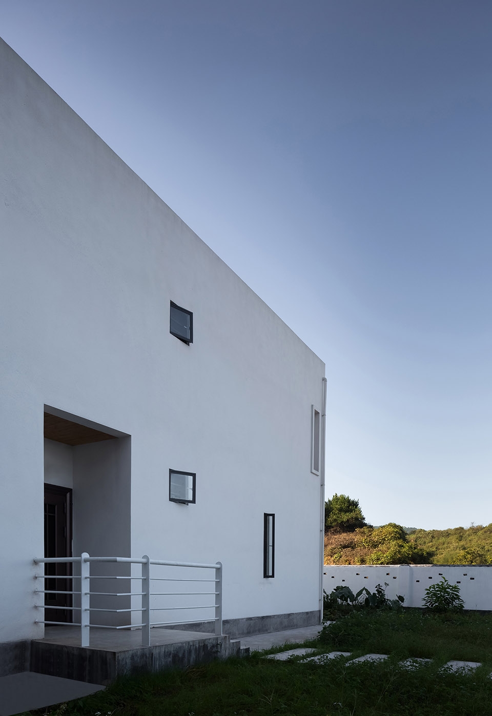 a white hillside house by ming ding spatial art studio