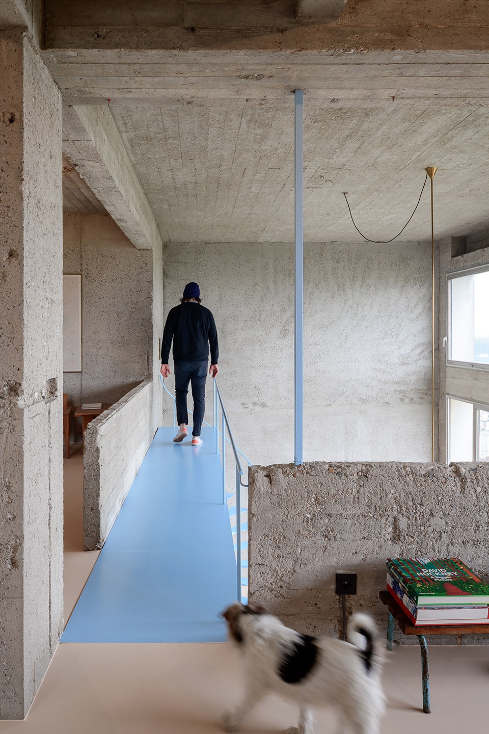 Brutalist duplex apartment in the Riverside Tower by Studio Okami Architects