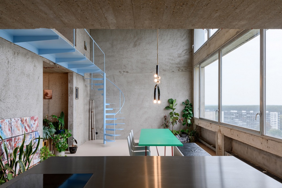 Brutalist duplex apartment in the Riverside Tower by Studio Okami Architects