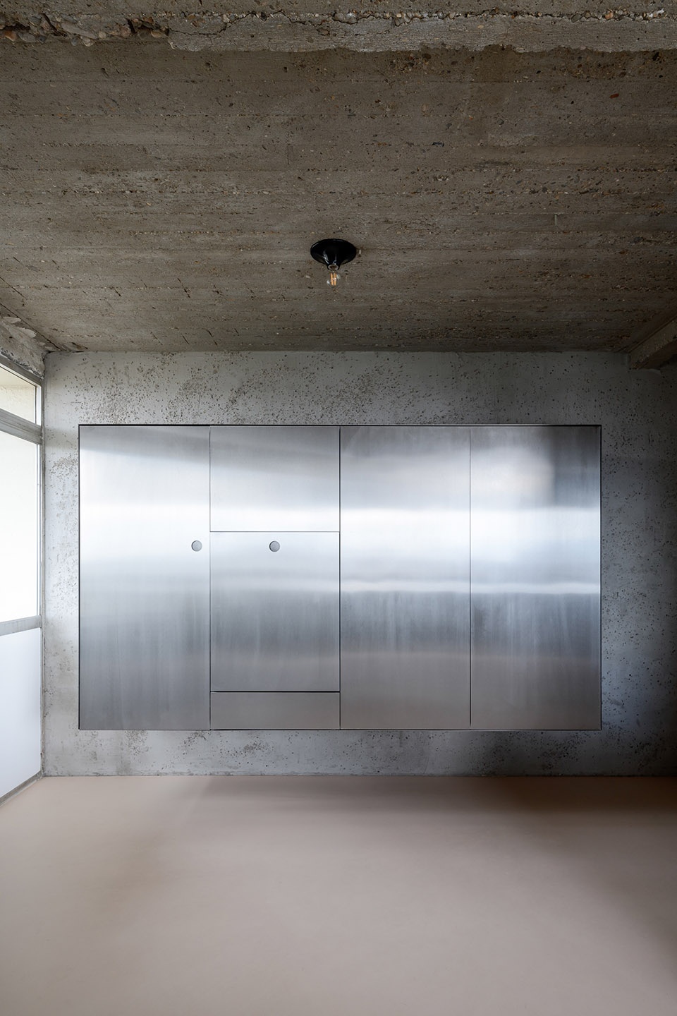 Brutalist duplex apartment in the Riverside Tower by Studio Okami Architects