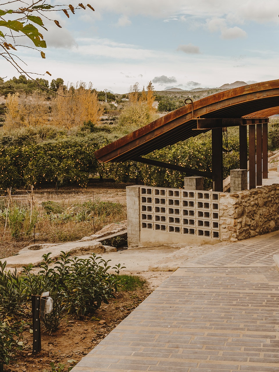 a pergola open to the fields by bona fide taller