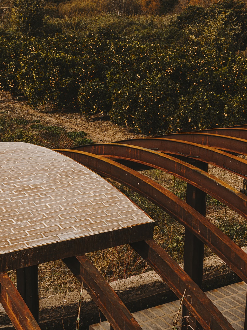 a pergola open to the fields by bona fide taller