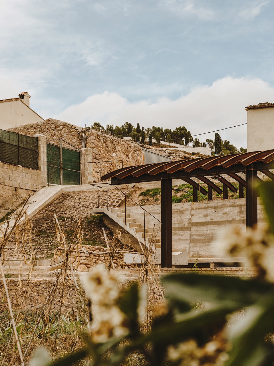 a pergola open to the fields by bona fide taller