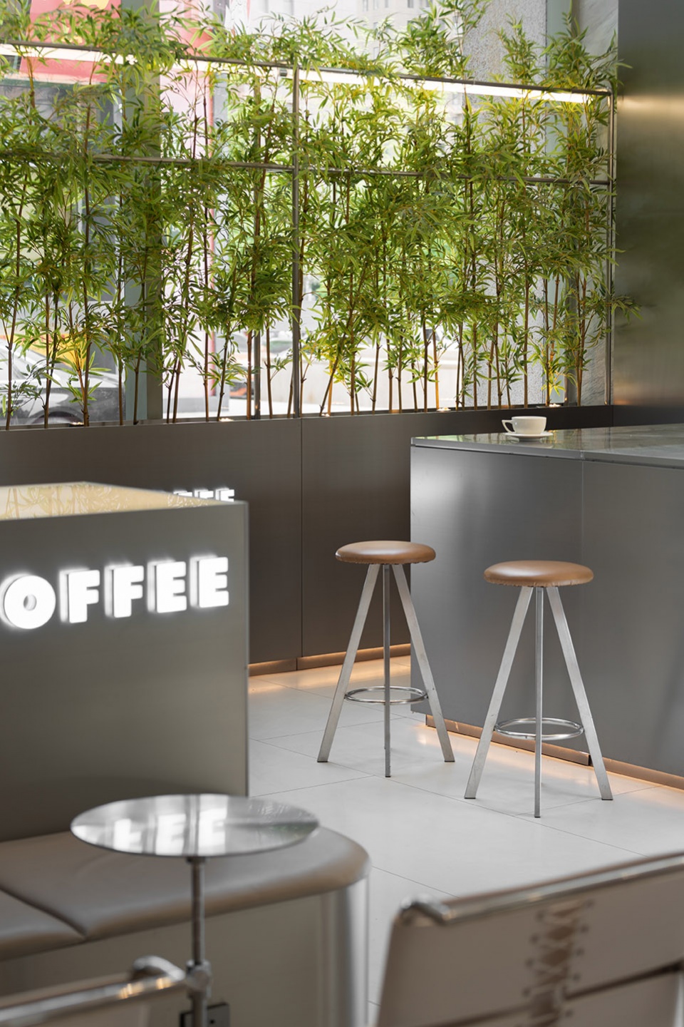 stainless steel and concrete intertwined ticle coffee series by daga architecture
