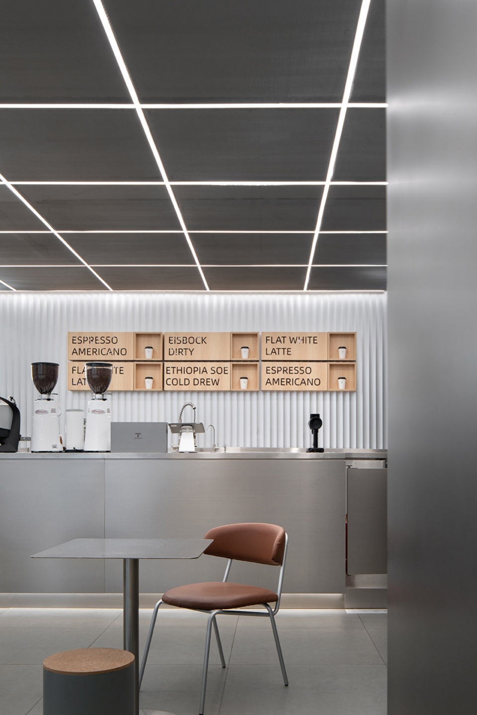 stainless steel and concrete intertwined ticle coffee series by daga architecture