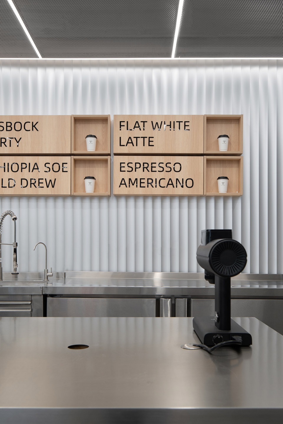 stainless steel and concrete intertwined ticle coffee series by daga architecture