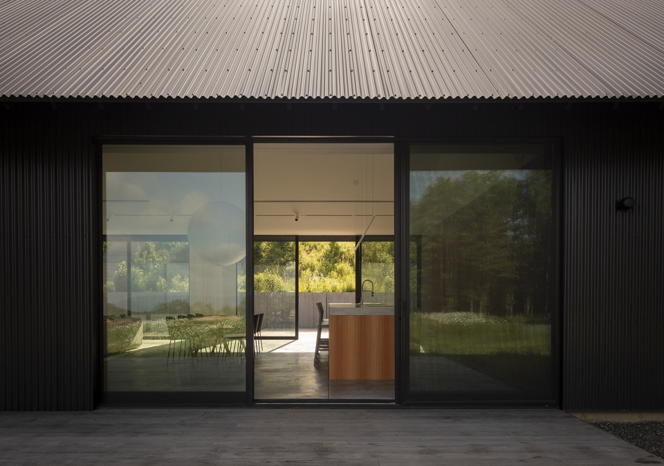 house in a meadow by group projects architecture