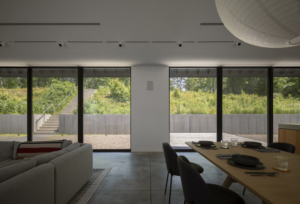 house in a meadow by group projects architecture