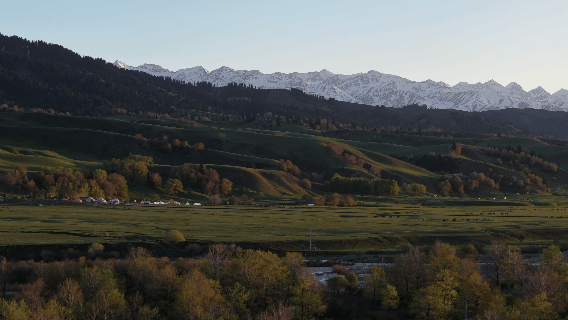 傍晚顺着河谷看向天山山脉的雪山群iew of Tianshan snow mountain ranges along the river valley at dusk© 尌林建筑